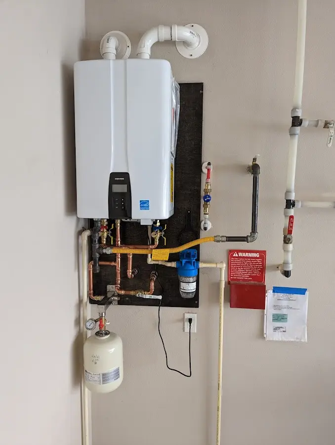 Professional plumber installing copper piping in a West Haven home